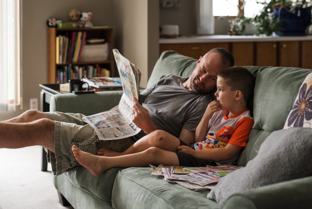 dad and child reading paper
