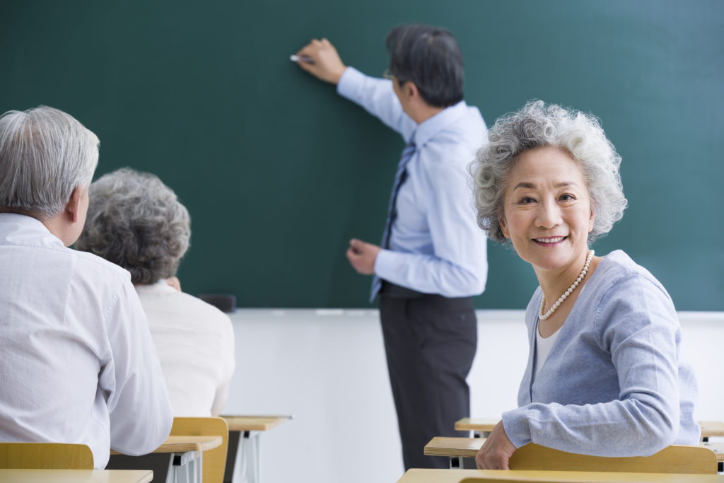 Senior Chinese adults having class at school